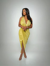 Woman wearing a yellow dress against a gray background