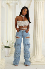Women wearing a embellished top and ripped jeans standing in front of classical columns.