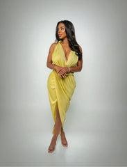 Woman wearing a yellow dress against a gray background